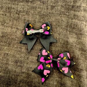 Black ribbon with pink and gold heart pigtail bows